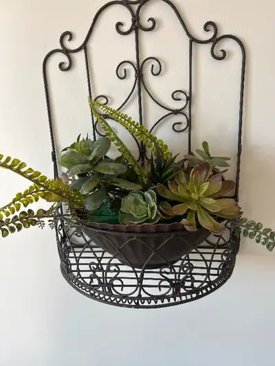 Artificial expensive real like Cactus plants in a arrangement in a pot. Not including hanging iron s...