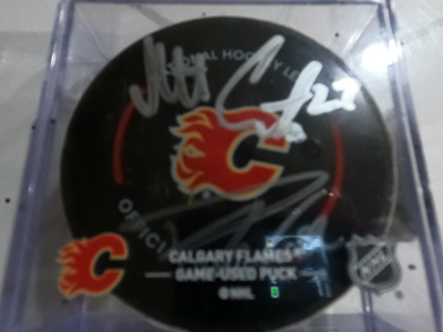 DUAL SIGNED FLAMES GAME USED PUCKS-WOLF,HUB,COR,WEEG,ZARY,11,20+, View more