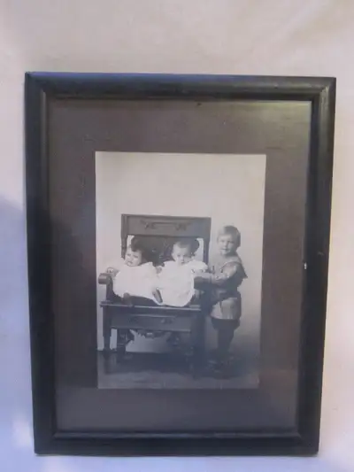 This old photo is in good used condition. Features Children on and by a chair. The frame measures 8&...