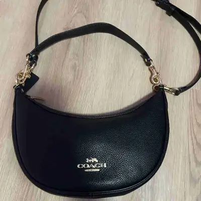 Real Coach black pebbled leather purse, comes with detachable shoulder and crossbody strap with gold...