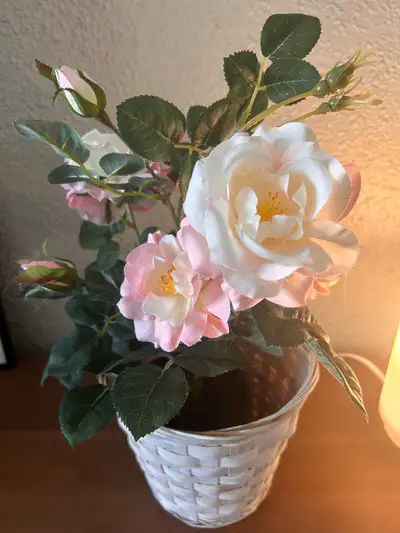 Realistic pink & white roses with lifelike leaves and buds Decorative white woven basket planter inc...