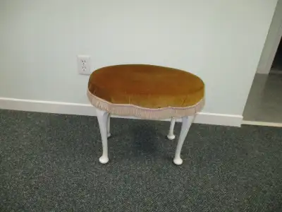 Very sturdy vintage solid wood footstool with padded top. Can remove fringe easily if you do not wan...