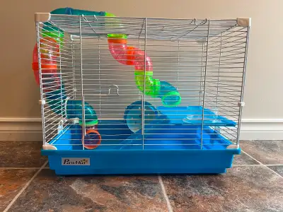 Hamster cage with wheel and tunnels.