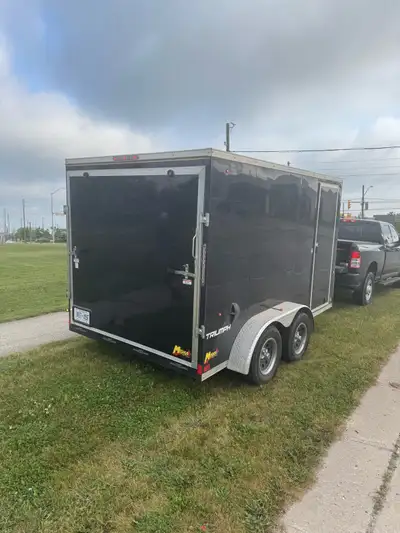 2022 Enclosed trailer with side door, LED lights inside and out, pull down ramp style back door, tan...