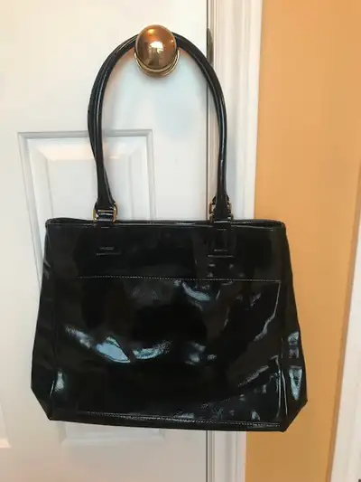 Never used black tote bag. Imitation patent leather with double handles and top dome closure. Measur...