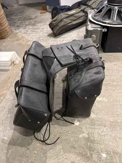 New black motorcycle bags. Never used. Made by All American Rider. Likely vinyl.