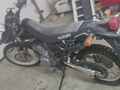 Low low km almost new!!!! I'm selling my road legal DR650 Suzuki, a versatile dual-sport motorcycle...