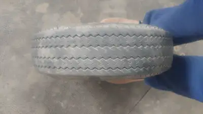 Carlisle trailer tire. Good tread but partial cut in sidewall.