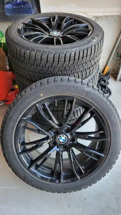 Selling a set of used BMW rims with winter tires, sized at 245/45R19, offering both style and perfor...