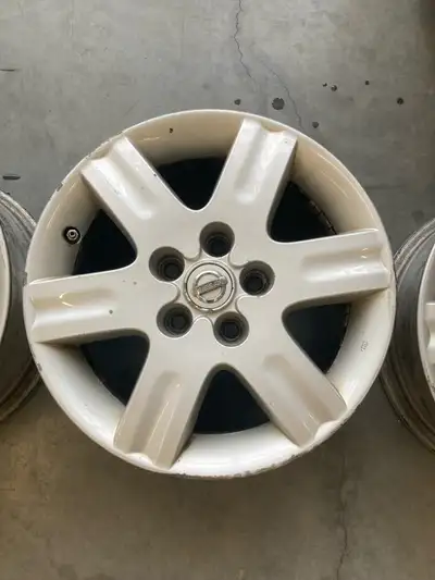 I'm selling a set of four Nissan rims, each measuring 16 inches in diameter. These rims are in used...