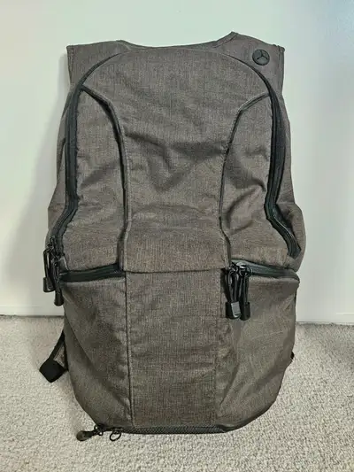 Photography backpack, dark gray colour, orange interior. Contains a lot of pockets and pouches for c...