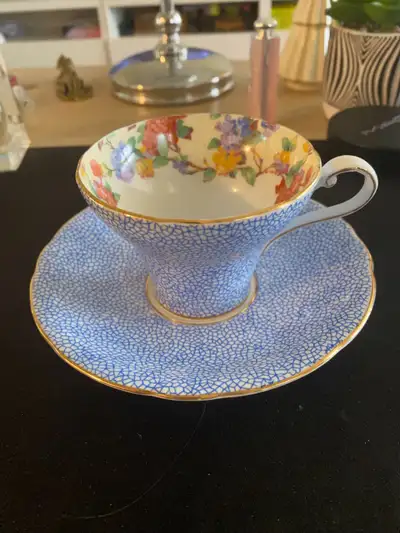 This is a Royal Aynsley teacup and saucer in excellent condition, featuring a charming blue and flor...