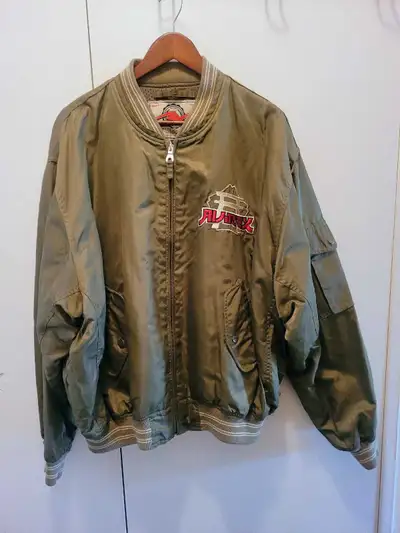 Rock a piece of vintage flair with this olive green Avirex Bomber Jacket, a true statement piece in...