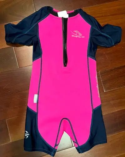 Size 6 Stingray wetsuit. This is a partial wetsuit. The pink is neoprene. The blue is a mesh type fa...