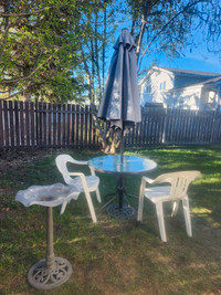 Patio table with 2 white chairs and bird bath