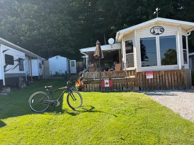 This charming, well-maintained used park model trailer offers the perfect cozy getaway for your seas...