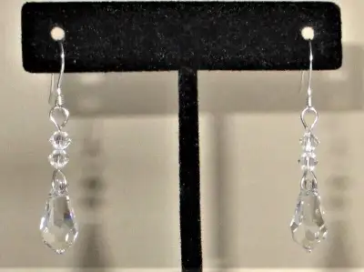 NEW. Swarovski fishhook pierced earrings are made of clear Swarovski crystals-2 multifaceted crystal...