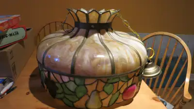 This is a very heavy & large slag glass Tiffany chandelier in good condition (1 panel has a hairline...