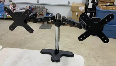 Monitor arm supports two monitors. Can adjust height and angle of your screens. McBay Road/Colborne...