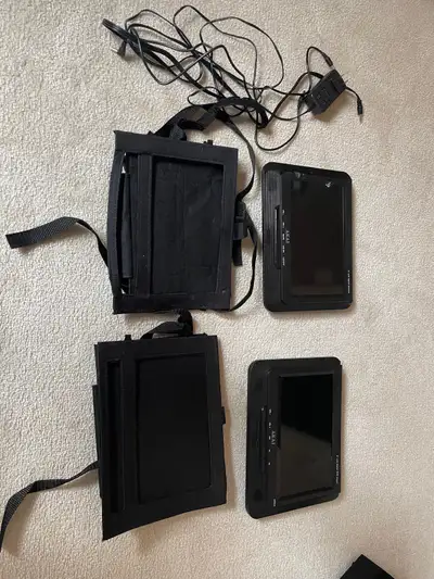 DVD player with 2 LCD screens (9”) with holders to attach to backrest of vehicle. Can use one or con...