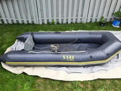 lightly used 10' inflatable boat with motor, paddles, lifejacket, anchor, foot pump, gas can Motor s...