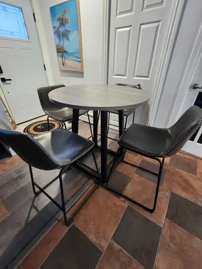 5 peice table and chairs counter height Table is 36" in diameter 36" high. Chairs measure 25" floor...