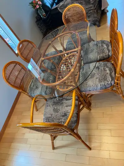 Made by Ratana. Oval Dining Table Glass Top 62”x42”. 2 arm chairs. 4 other chairs. Beautiful. Solid....