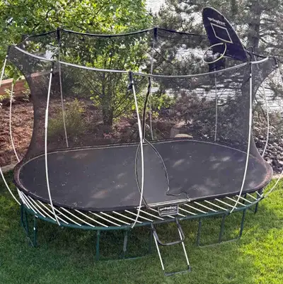 8ft x 13ft large oval trampoline in great condition includes basketball net and step; must disassemb...