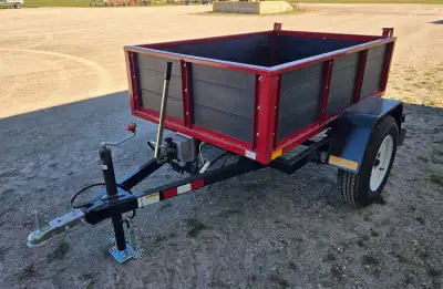Brand New, hydraulic dump trailer features a hand pump for easy raising and lowering of the body for...