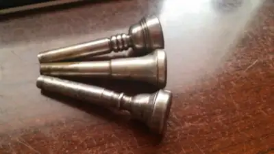 METAL TRUMPET STAND AND 3 SILVER PLATED MOUTHPIECES, View more