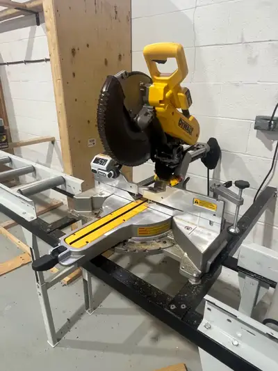 This is a DeWalt 12" sliding compound mitre saw, perfect for precision woodworking and construction...