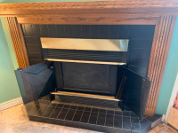propane fireplace and oak mantel