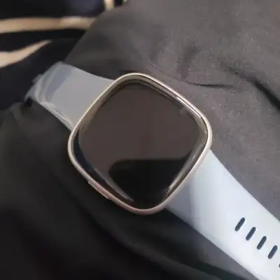 Comes with the original charger and both small and large bands. It is waterproof. Has some small scr...