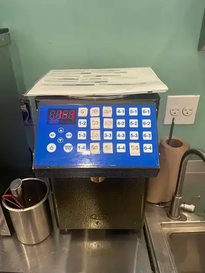 Commercial fructose / sugar syrup dispenser commonly used in bubble tea shops and cafés. Programmabl...