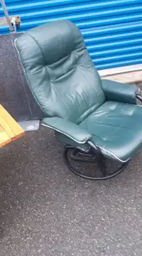 GREEN LEATHER CHAIR SWIVELS AND RECLINES