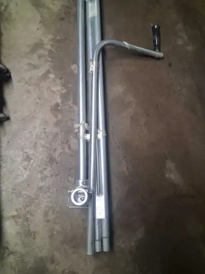 This appears to be a manual crank handle assembly (also called a crank wand or roll crank) for opera...