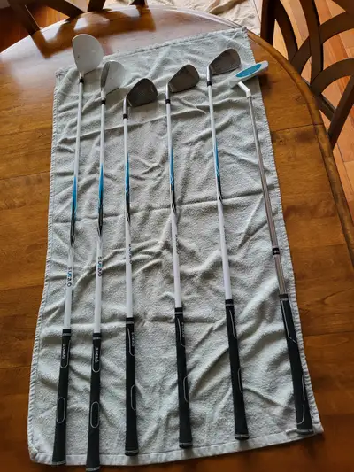 Two beginner half sets of golf clubs, View more