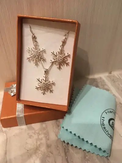 Handmade jewelled snowflake necklace and earring set. New in box, never worn. Comes with polishing c...