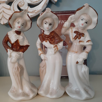 Trio of vintage fine porcelain fancy dress lady figurines from Jaeger, hand painted with a classic b...