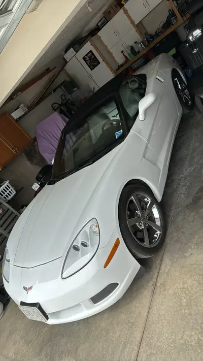 Check out this sleek, white Chevrolet Corvette convertible, a true head-turner that blends performan...