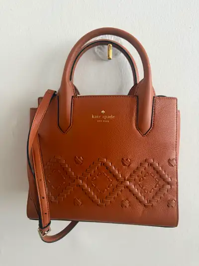 New Kate Spade New York satchel in cognac brown pebbled leather. This bag has a woven diamond patter...