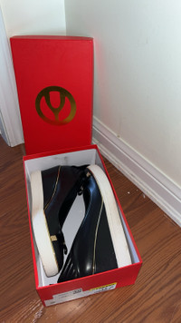 Women’s black with gold wedge pumps