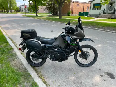 Extras include crash bars, a skid plate, an aftermarket exhaust, a 16 tooth sprocket and dual 12 vol...