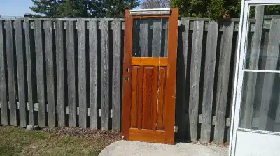 This is a standard wood exterior door in decent shape for an older home or a backyard shed project....