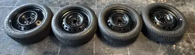 Lightly used Goodyear Ultragrip snow tires with approximately 75% tread left on new steel wheels, 5*...