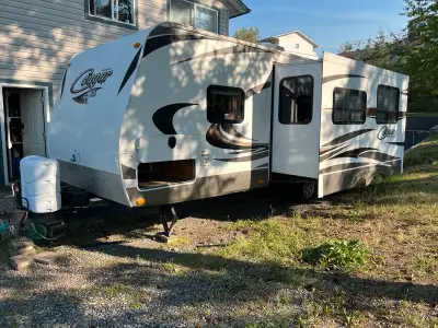 I'm selling a 2014 Cougar Travel Trailer, perfect for your next adventure! This spacious trailer is...