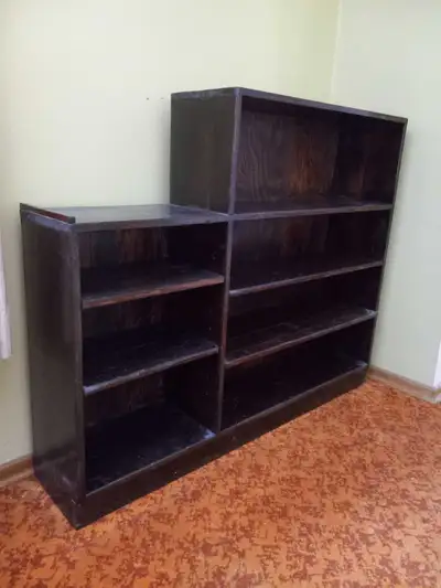 Solid dark wood book case w 4 shelves and 3 shelves on one side. Measures: 50 inch long total x 10.5...