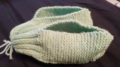 Mint green hand knitted slippers. Approx. size 8