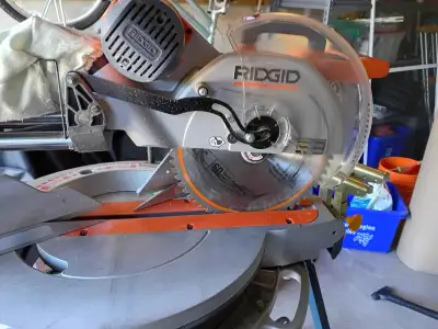 Rigid 12 inch compound mitre saw and heavy duty collapsible stand.