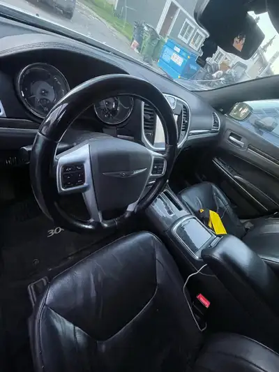 White Chrysler 300c 2011 5.7 hemi with black leather interior. This vehicle has a panoramic sunroof,...